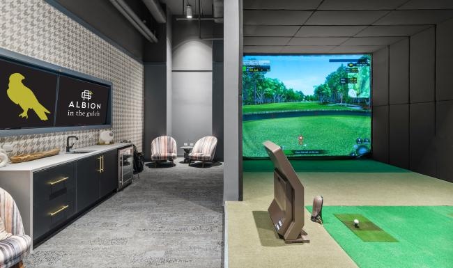 a room with a golf simulator