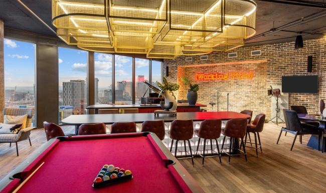 a clubroom with a pool table, tables and chairs