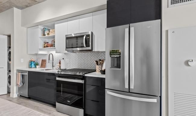 a kitchen with black and white cabinets